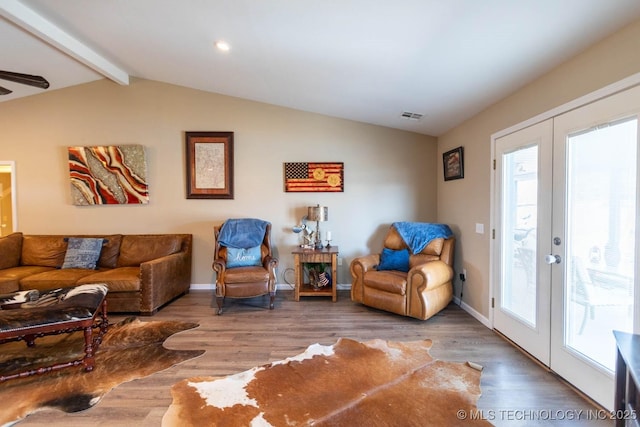 living room featuring ceiling fan, wood-type flooring, lofted ceiling with beams, and french doors