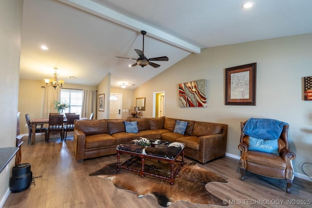 living room with ceiling fan with notable chandelier, wood-type flooring, and vaulted ceiling with beams