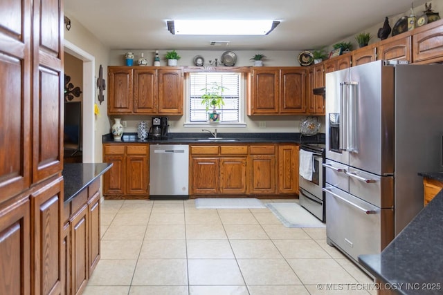 kitchen featuring light tile patterned floors, sink, and appliances with stainless steel finishes