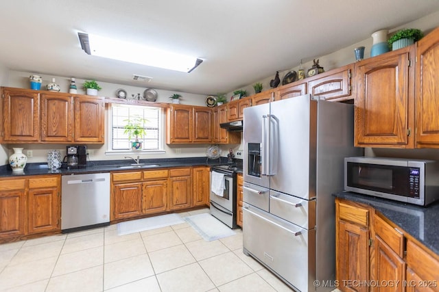 kitchen with light tile patterned floors, sink, and stainless steel appliances