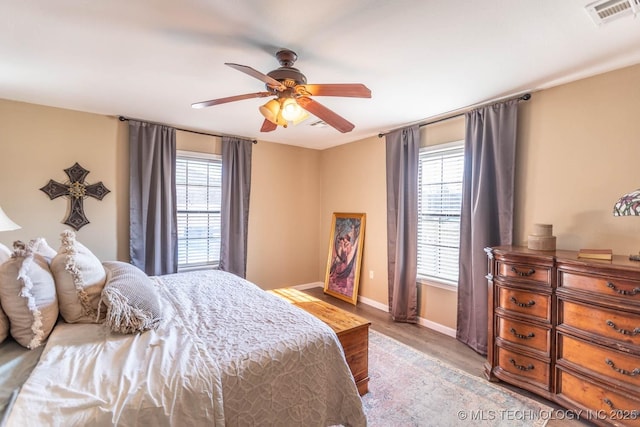 bedroom with ceiling fan and light hardwood / wood-style floors