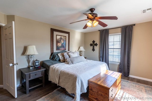 bedroom with ceiling fan and dark hardwood / wood-style flooring