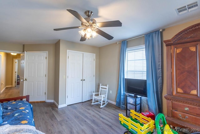 bedroom featuring ceiling fan, a closet, and hardwood / wood-style floors