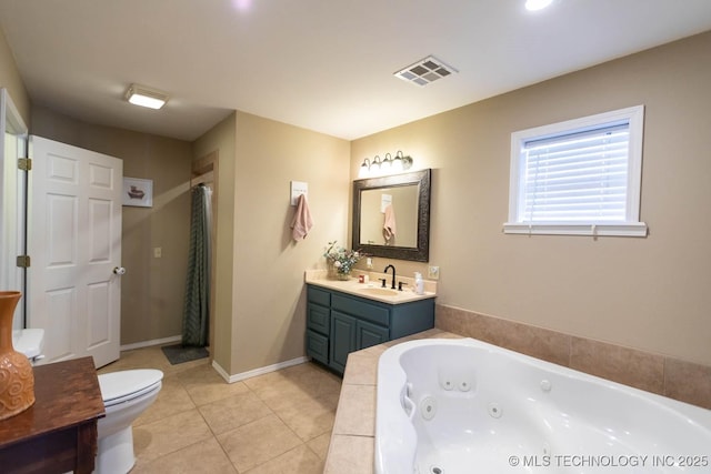 bathroom with toilet, tile patterned flooring, a relaxing tiled tub, and vanity