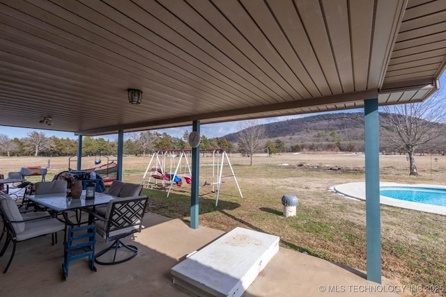 view of patio / terrace with a mountain view and a playground