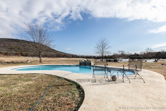 view of pool with a patio area and a mountain view