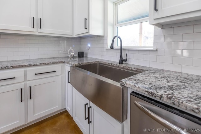 kitchen with tasteful backsplash, white cabinets, light stone countertops, and dishwasher