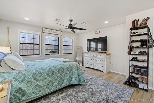 bedroom featuring ceiling fan and light hardwood / wood-style flooring