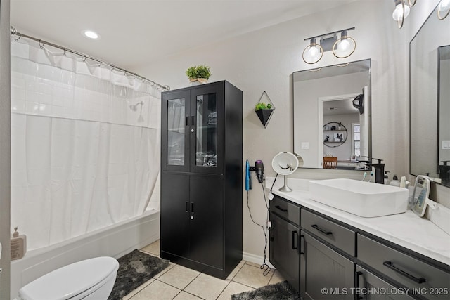 full bathroom featuring toilet, vanity, tile patterned flooring, and shower / bath combo