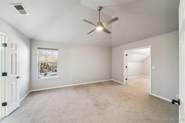 carpeted empty room featuring ceiling fan and lofted ceiling