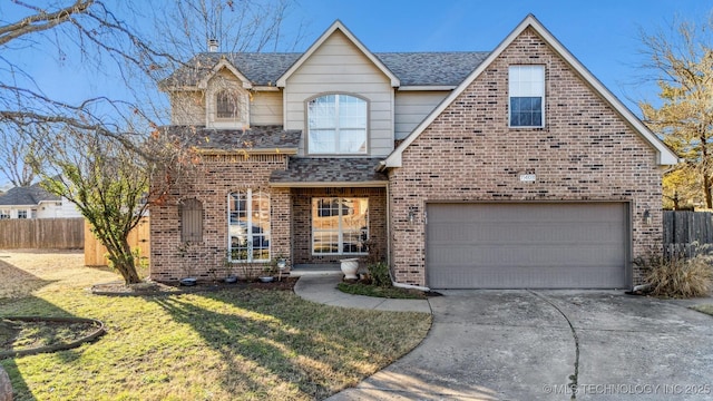 view of front of property featuring a garage and a front lawn