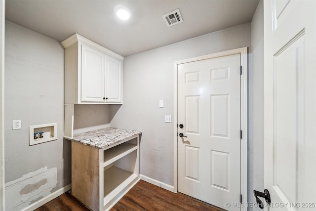 laundry room featuring dark hardwood / wood-style floors, washer hookup, and cabinets