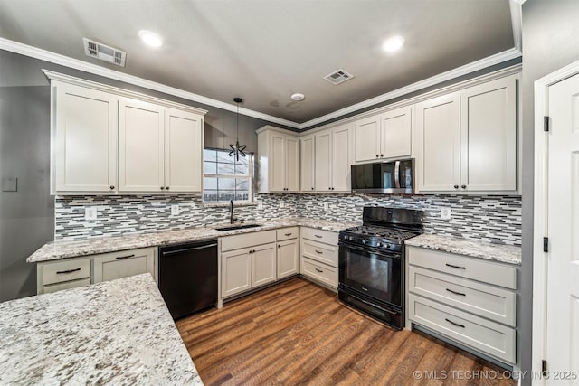 kitchen featuring decorative light fixtures, dark hardwood / wood-style floors, black appliances, decorative backsplash, and sink