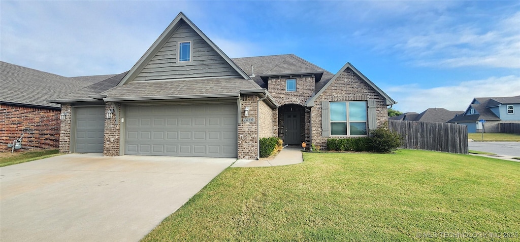 view of front of house with a garage and a front yard