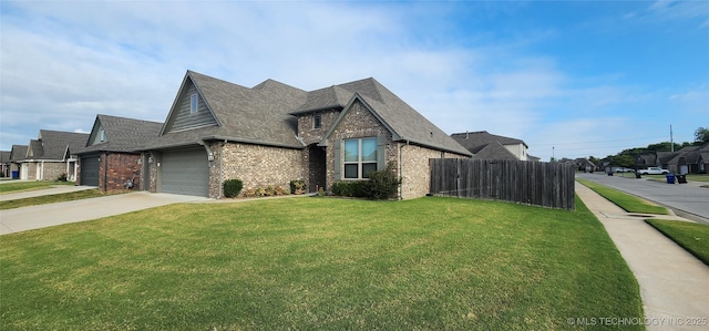 view of front of home with a front lawn and a garage