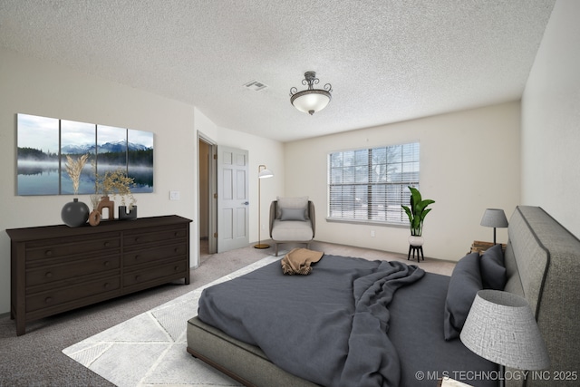 carpeted bedroom featuring visible vents and a textured ceiling