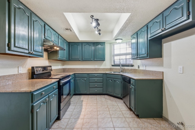 kitchen featuring sink, light tile patterned floors, appliances with stainless steel finishes, a tray ceiling, and a textured ceiling