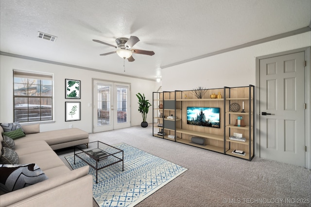 carpeted living room featuring visible vents, french doors, a textured ceiling, and ornamental molding