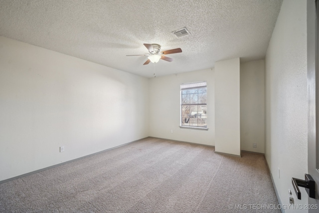 unfurnished room featuring light carpet, visible vents, a textured ceiling, and a ceiling fan