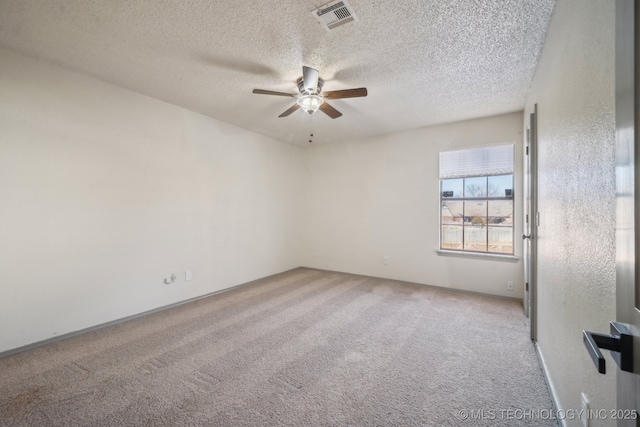 empty room featuring a textured ceiling, a ceiling fan, visible vents, and light carpet