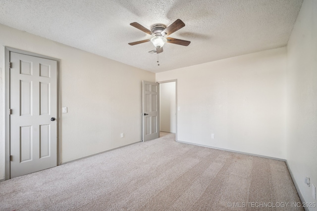 unfurnished bedroom with a ceiling fan, visible vents, carpet floors, and a textured ceiling