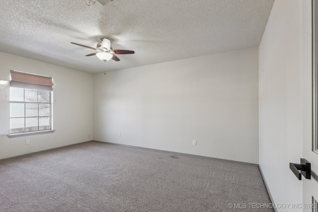 carpeted empty room featuring a ceiling fan and a textured ceiling