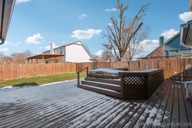 wooden terrace with a fenced backyard