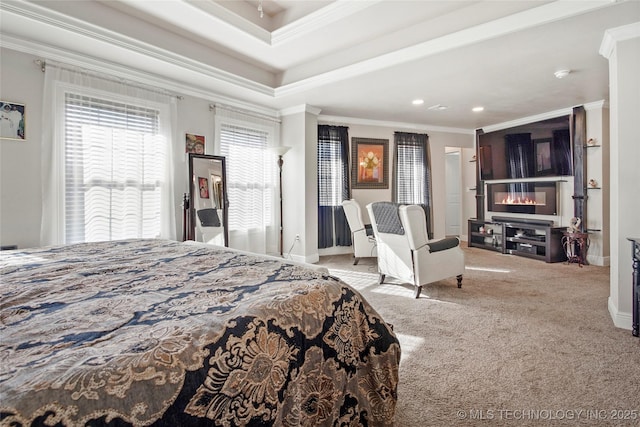 carpeted bedroom with a tray ceiling and crown molding