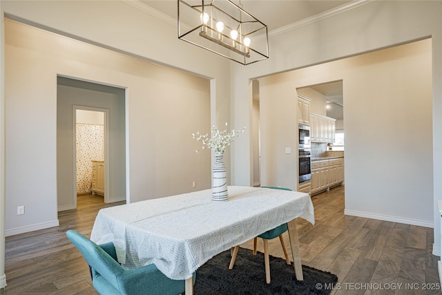 dining area with dark hardwood / wood-style flooring and crown molding