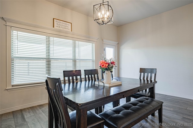 dining space featuring plenty of natural light, a chandelier, and hardwood / wood-style floors