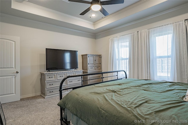 bedroom with ceiling fan, ornamental molding, light colored carpet, and a raised ceiling