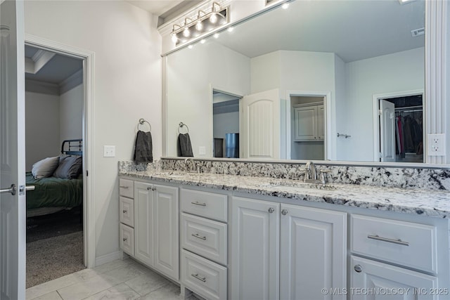 bathroom featuring ornamental molding, tile patterned floors, and vanity