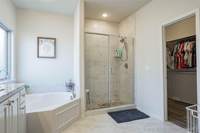 bathroom with plus walk in shower and vanity