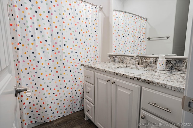 bathroom featuring hardwood / wood-style flooring and vanity