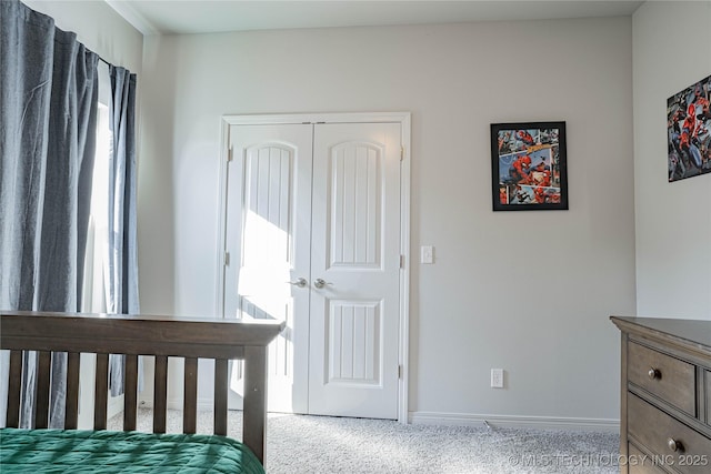 bedroom featuring light carpet and a closet