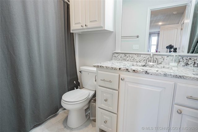 bathroom with toilet, vanity, a shower with curtain, and tile patterned floors