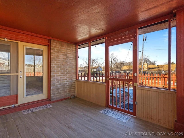 unfurnished sunroom with wood ceiling