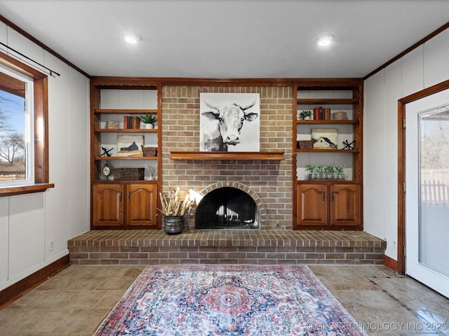 living room featuring a brick fireplace and ornamental molding