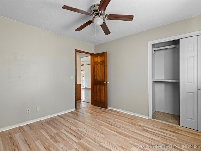 unfurnished bedroom with ceiling fan, a closet, and light hardwood / wood-style floors