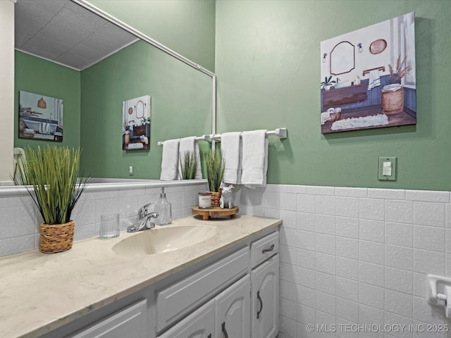 bathroom featuring tile walls and vanity