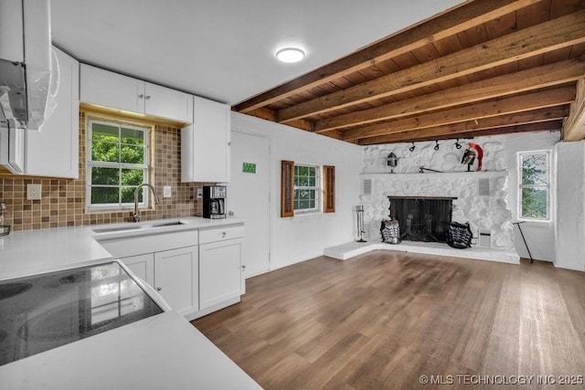 kitchen featuring wood ceiling, white cabinetry, decorative backsplash, sink, and beam ceiling