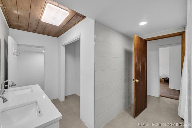 bathroom with wood ceiling and vanity