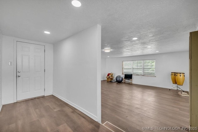 interior space featuring wood-type flooring and a textured ceiling