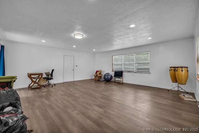 miscellaneous room with wood-type flooring and a textured ceiling