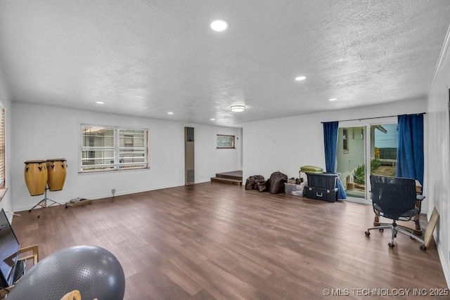 interior space with a textured ceiling and hardwood / wood-style flooring