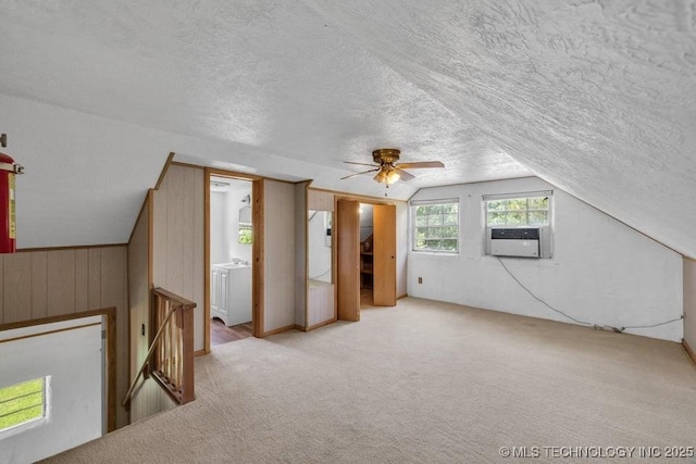 bonus room with ceiling fan, cooling unit, lofted ceiling, and wooden walls