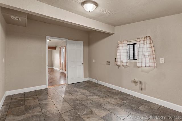 empty room with a textured ceiling