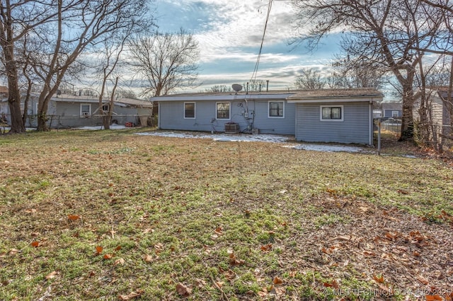 rear view of property with a lawn