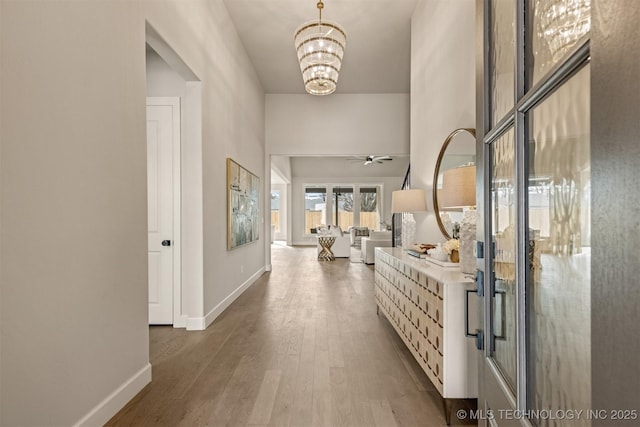 corridor featuring a chandelier and hardwood / wood-style floors