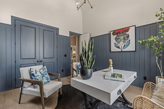 office area featuring light hardwood / wood-style floors and a high ceiling